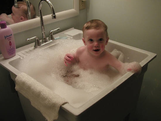 Bath time in the utility tub.  Zeke is a full-action kid, which means that he takes _lots_ of baths.