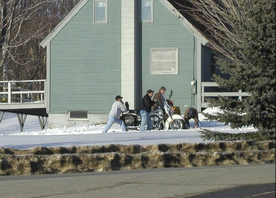 Ah, the early spring optimists.  We were out for a drive, last day of Feburary and saw these fella struggling to get their motorcycle out of the shed and out to the driveway.  We sat and watched them for at least 10 minutes.  I guess it is some form of addiction for bikers, they just <b>have</b> to get out as soon as possible.